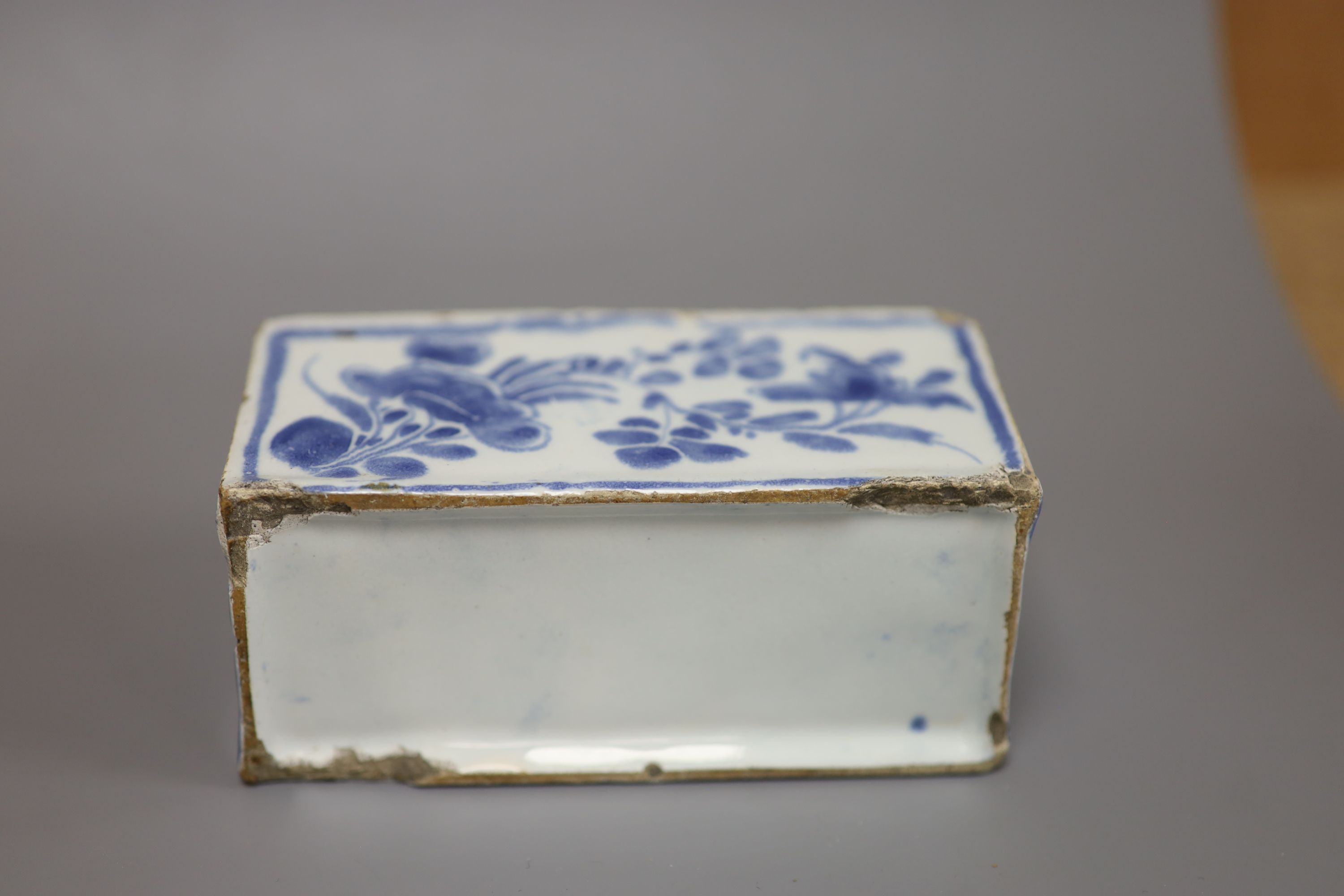 An 18th century Delft ware flower brick, length 12.5cm